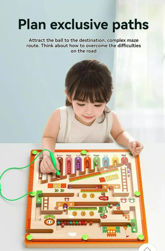 kid playing pen guided magnetic maze ball game