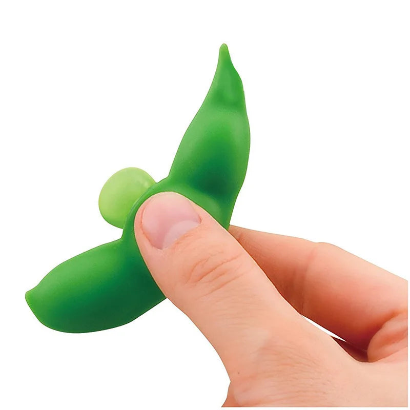 Hand squeezing pea pod stress toy