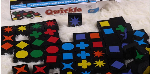 Close-up of colourful Qwirkle sensory tool pieces on a table.