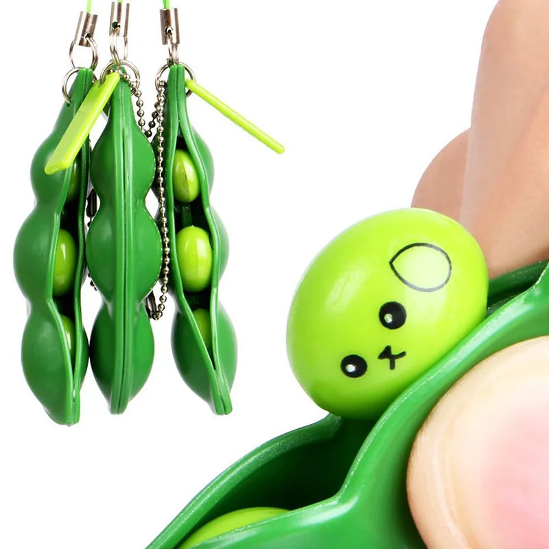 Close-up of squishy pea popping from pod