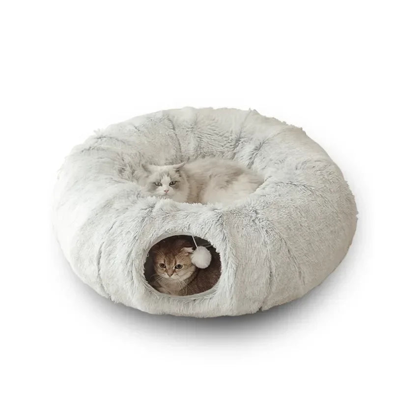 Cat peeking through peephole of plush cat tunnel bed