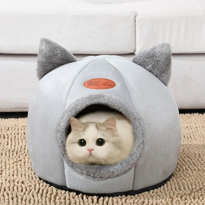 Cat curled up inside plush enclosed bed