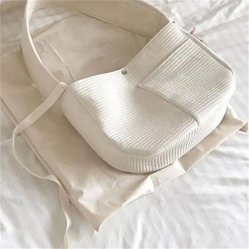 Breathable canvas cat carrier sling for outdoor travel adventures.