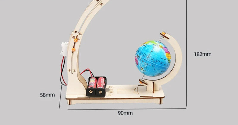 Close-up of child assembling STEM day-night globe with educational guide