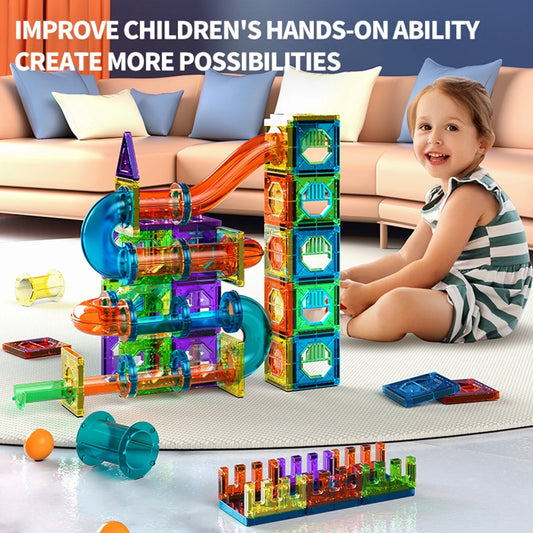 Child building marble run with magnetic tiles