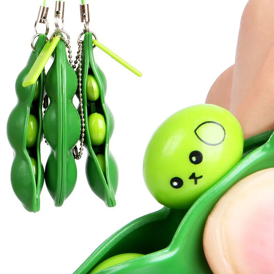 Close-up of squishy pea popping from pod