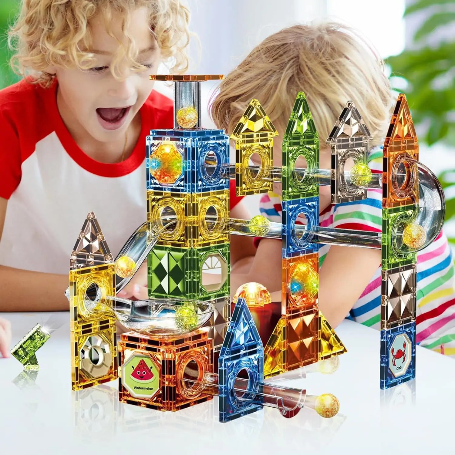 Interactive magnetic building set with rolling marbles