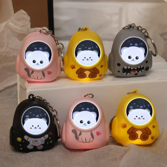 Cat keychain flashlight for purse or bag lightPink cat-shaped LED flashlight attached to keyring glowing in dark
