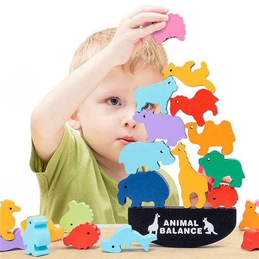 Child stacking wooden rainbow balance blocks with dinosaur and animal shapes